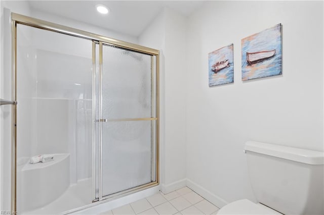 bathroom with a shower with shower door, toilet, and tile patterned flooring