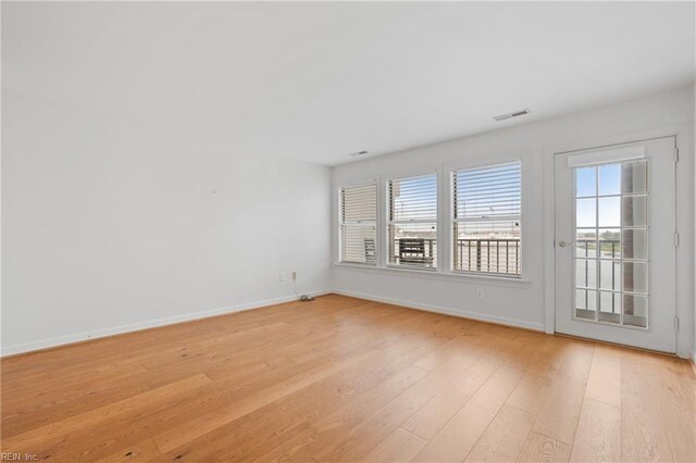 empty room with light hardwood / wood-style flooring