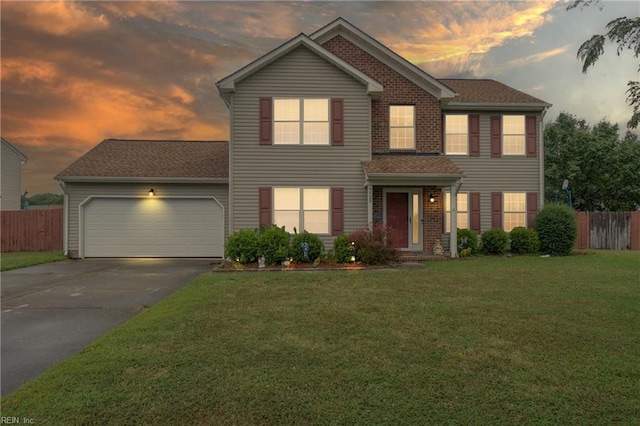 view of front of house featuring a lawn and a garage