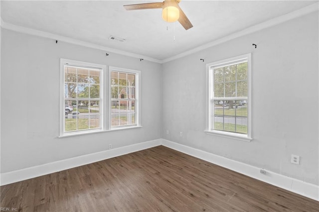 spare room featuring ceiling fan, hardwood / wood-style flooring, and crown molding