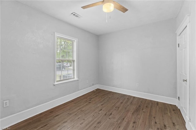 spare room featuring ceiling fan and dark hardwood / wood-style flooring