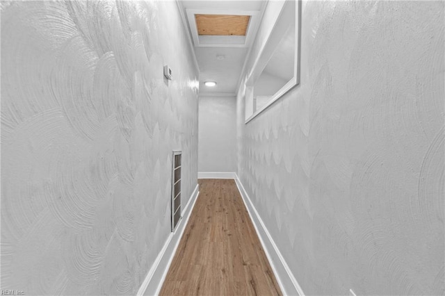 hallway with hardwood / wood-style floors