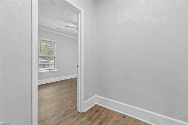 spare room featuring hardwood / wood-style flooring and crown molding