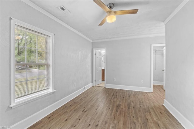 empty room featuring crown molding, ceiling fan, and light hardwood / wood-style flooring