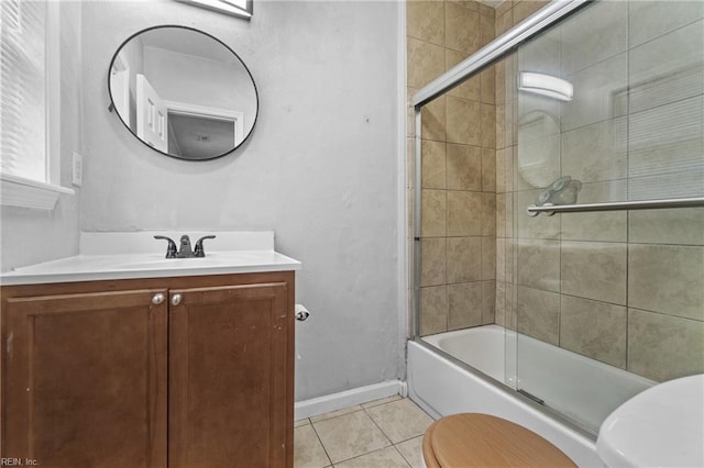 full bathroom with enclosed tub / shower combo, vanity, tile patterned flooring, and toilet