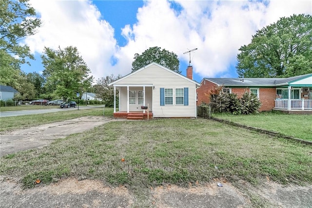 view of front of property featuring covered porch and a front yard