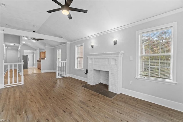 unfurnished living room with ceiling fan, hardwood / wood-style flooring, a fireplace, and vaulted ceiling