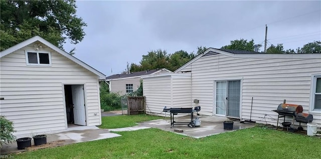 back of house featuring a yard and a patio