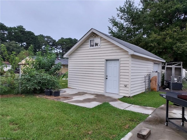 view of outbuilding with a yard