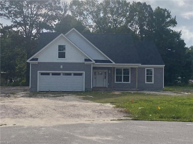 view of front facade featuring a garage and a front lawn