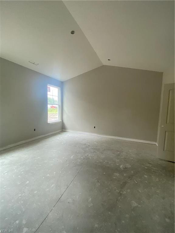 bonus room featuring concrete floors and lofted ceiling