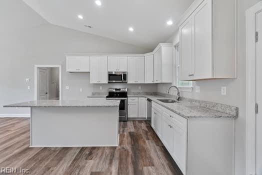 kitchen with white cabinets, a center island, sink, and appliances with stainless steel finishes