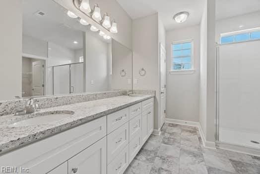 bathroom with vanity and an enclosed shower