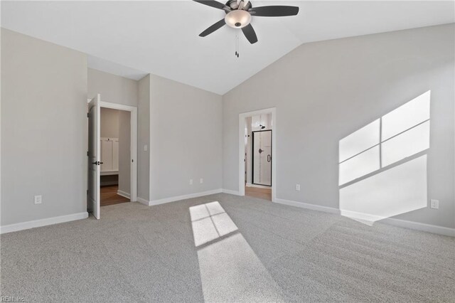 carpeted empty room featuring ceiling fan and vaulted ceiling