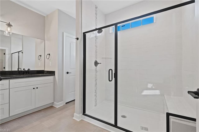 bathroom with vanity and a shower with door