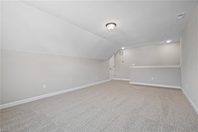 bonus room with carpet floors and vaulted ceiling