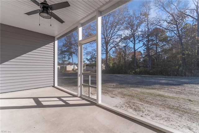 unfurnished sunroom with ceiling fan and a healthy amount of sunlight