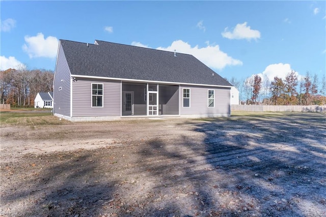 back of property with a sunroom