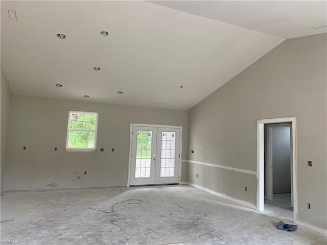 spare room with french doors and vaulted ceiling