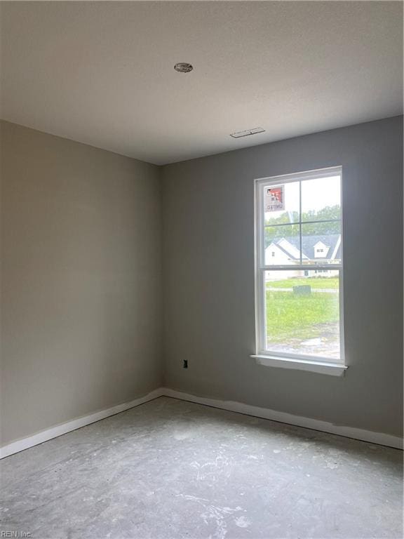 spare room featuring concrete flooring