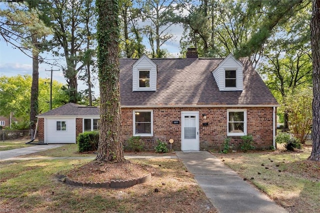 new england style home featuring a front yard