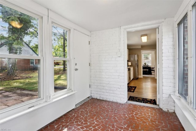 unfurnished sunroom featuring a wealth of natural light