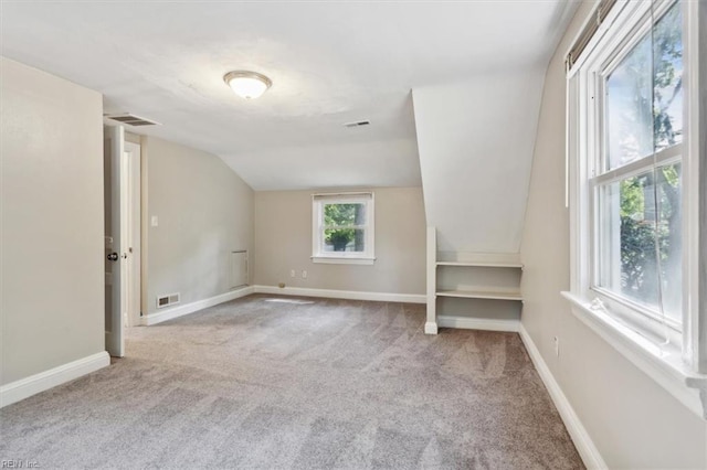 bonus room featuring carpet flooring and vaulted ceiling