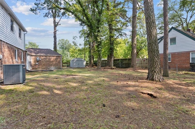 view of yard with a storage shed and central AC