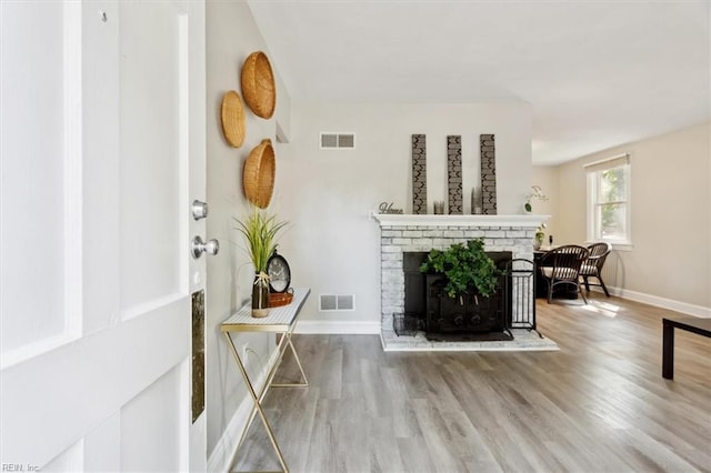 living room with hardwood / wood-style flooring and a fireplace