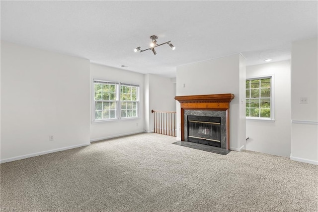 unfurnished living room with a fireplace and carpet flooring