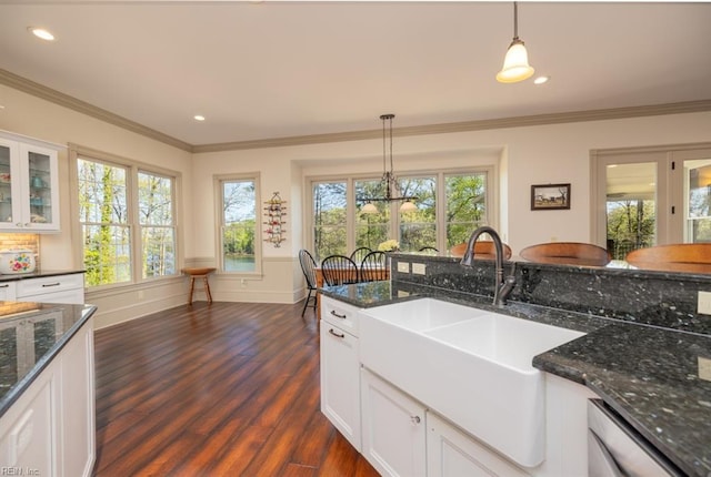 kitchen featuring pendant lighting, a healthy amount of sunlight, and white cabinetry