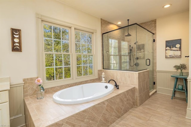 bathroom with vanity and separate shower and tub