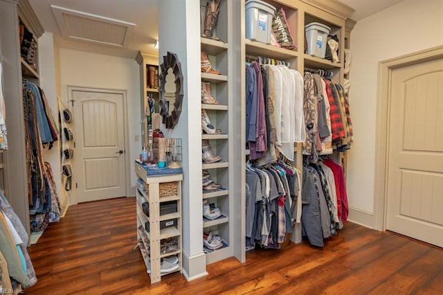 spacious closet with dark hardwood / wood-style flooring