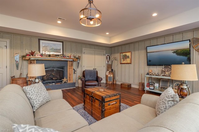 living room with an inviting chandelier and dark hardwood / wood-style floors