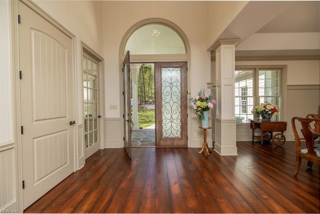 entryway with dark wood-type flooring, french doors, and ornate columns