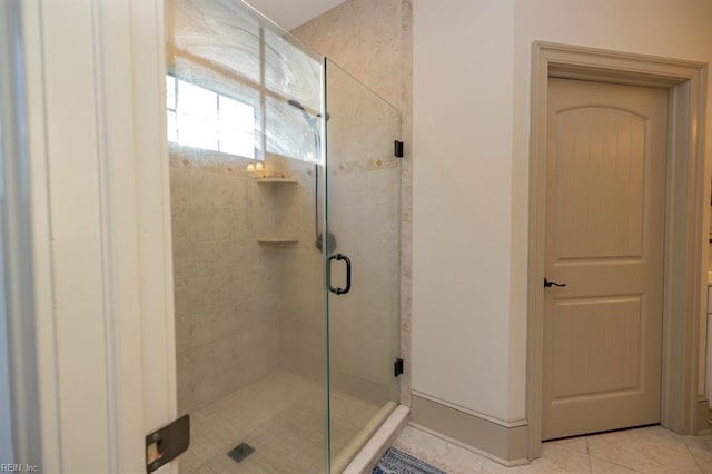 bathroom with tile patterned flooring and an enclosed shower