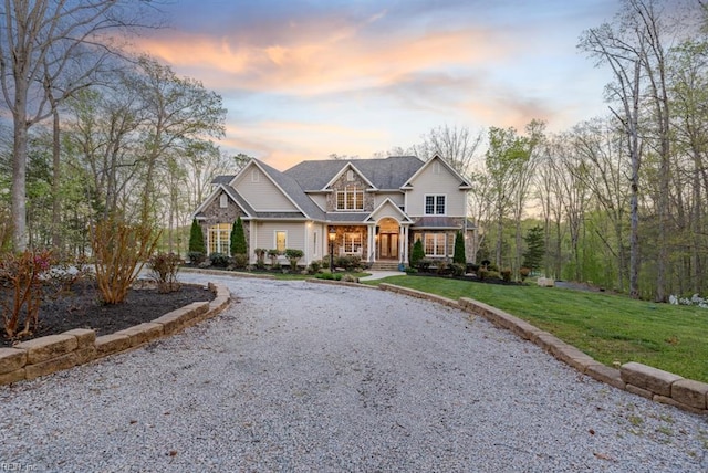 craftsman house with a lawn and covered porch