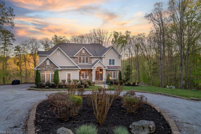 craftsman-style house with covered porch and a yard