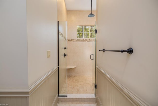 bathroom with tile patterned floors and a shower with shower door