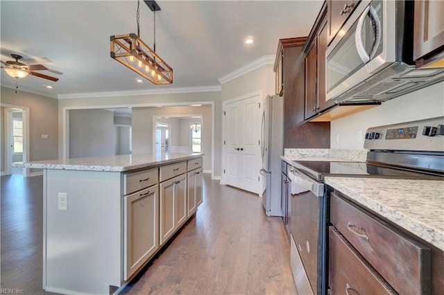 kitchen featuring appliances with stainless steel finishes, dark hardwood / wood-style floors, ceiling fan, and a wealth of natural light