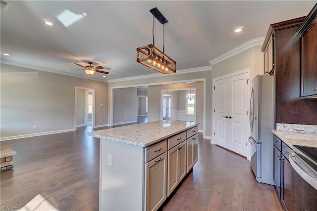 kitchen with light stone counters, dark hardwood / wood-style floors, a kitchen island, ceiling fan, and stainless steel fridge