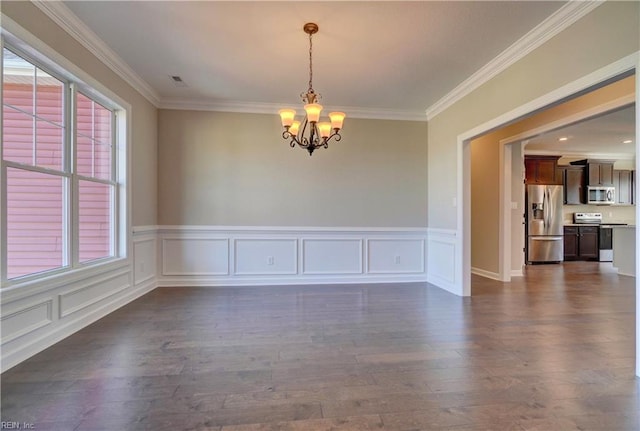 empty room with ornamental molding, dark wood-type flooring, a chandelier, and a healthy amount of sunlight