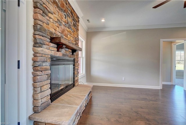 unfurnished living room featuring ornamental molding, ceiling fan, a fireplace, and dark hardwood / wood-style flooring