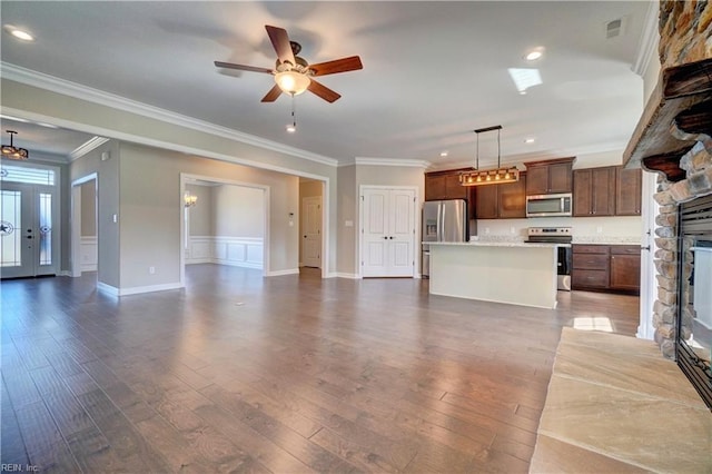 unfurnished living room with crown molding, a fireplace, dark hardwood / wood-style floors, and ceiling fan