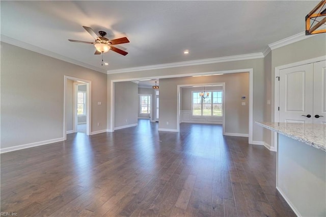 unfurnished living room featuring ornamental molding, ceiling fan, and dark hardwood / wood-style floors