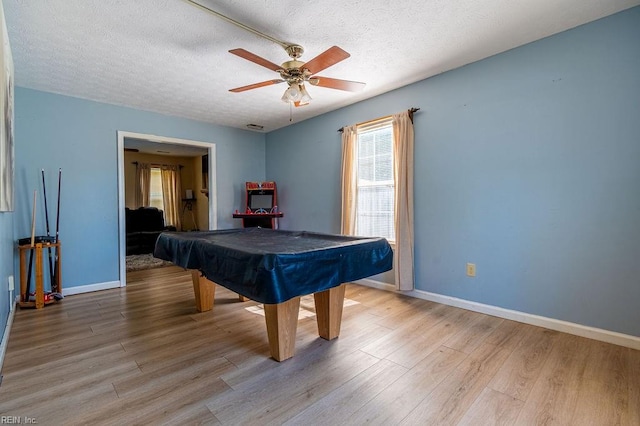 game room with ceiling fan, light hardwood / wood-style floors, a textured ceiling, and pool table