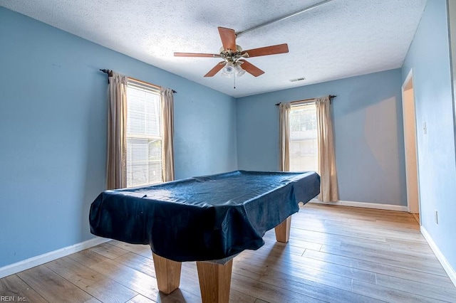 playroom featuring a textured ceiling, light wood-type flooring, ceiling fan, and billiards