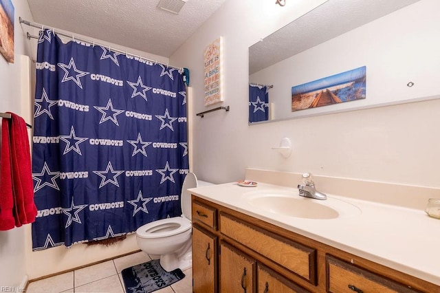 bathroom featuring a shower with shower curtain, vanity, a textured ceiling, tile patterned flooring, and toilet