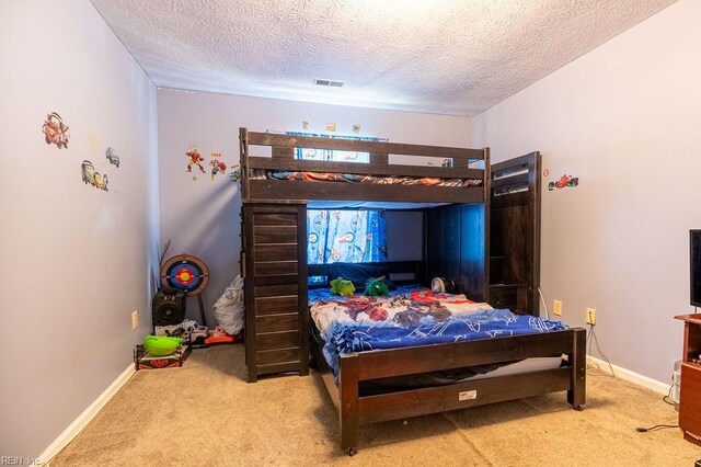 carpeted bedroom featuring a textured ceiling