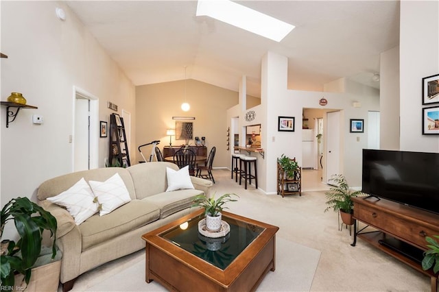 carpeted living room with lofted ceiling with skylight